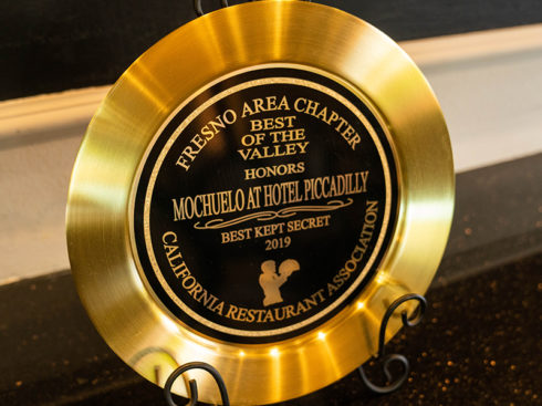 "Fresno Area Chapter Best of the Valley Honors Mochuelo at Hotel Piccadilly 'Best Kept Secret 2019' California Restaurant Association" award shaped like a plate