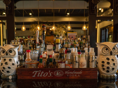 Mochuelo bar tap with various ingredients and ceramic owl figurines