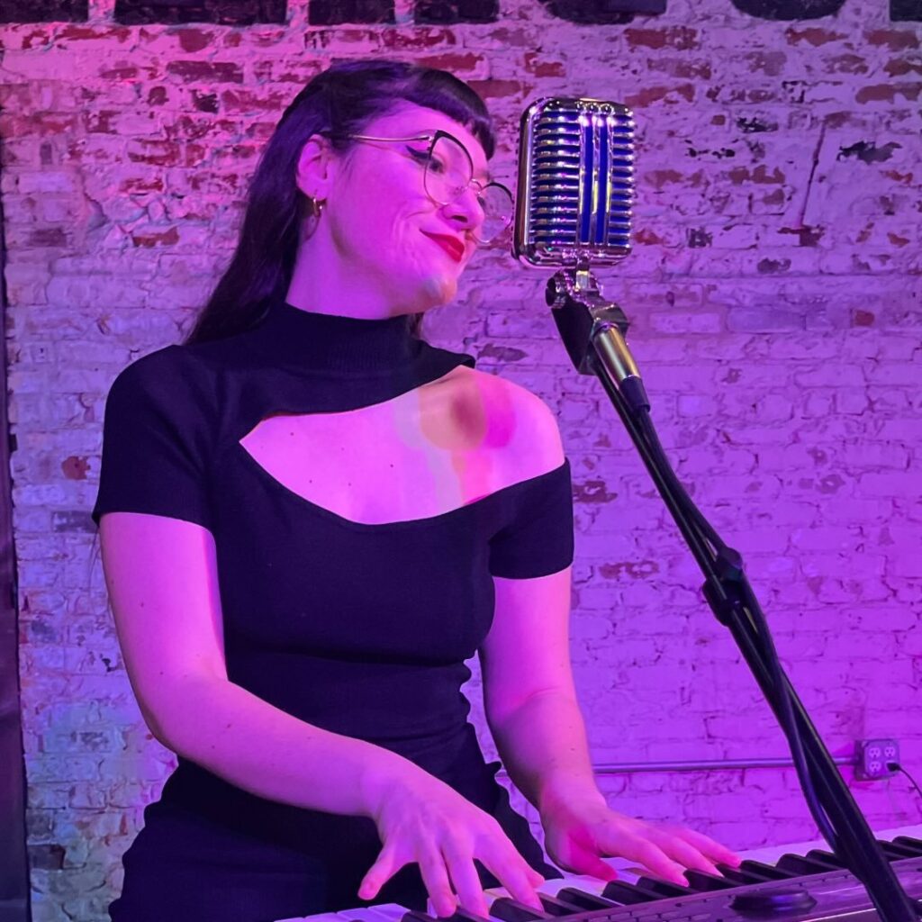 Ashley Rose Headshot Playing Keyboard